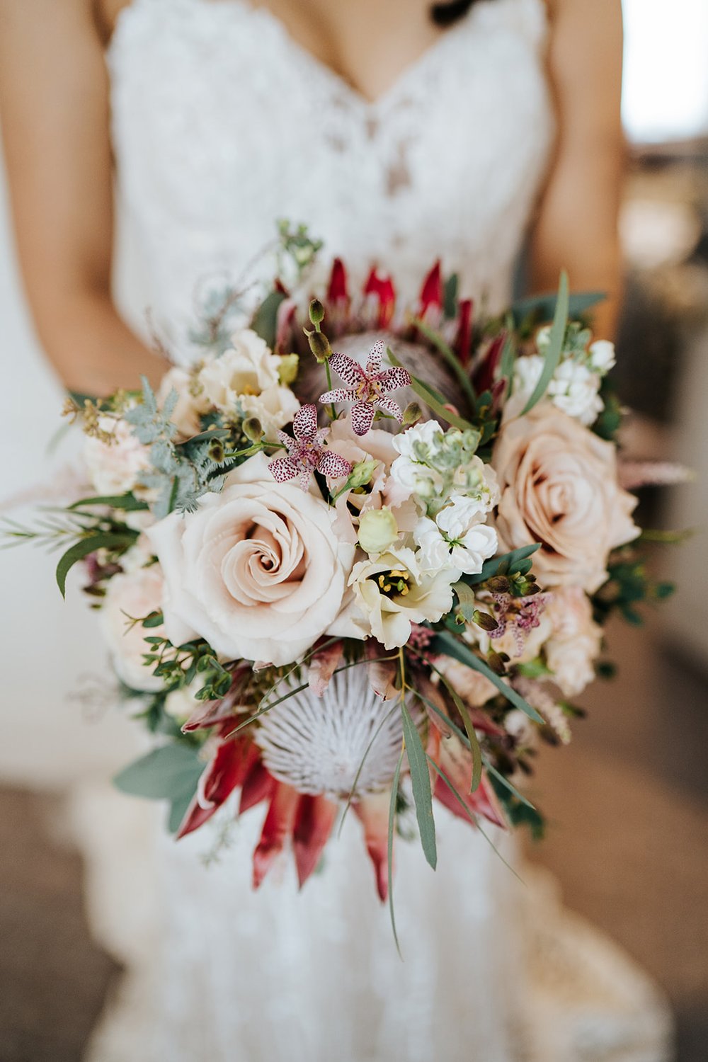 Bride's gorgeous king protea wedding bouquet with muted tones by Johanna Pedrick