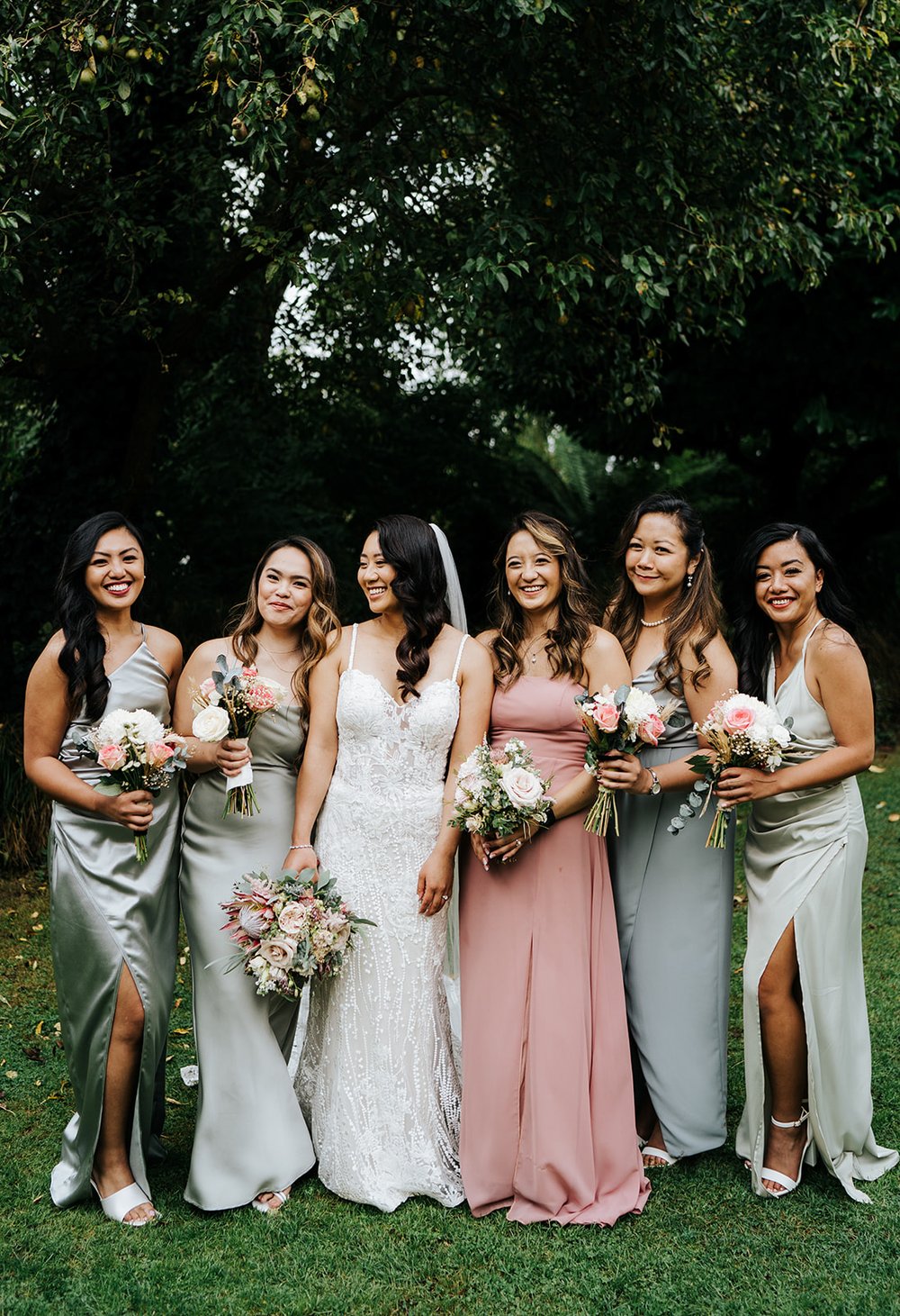 Staged group photograph of bride and her bridesmaids