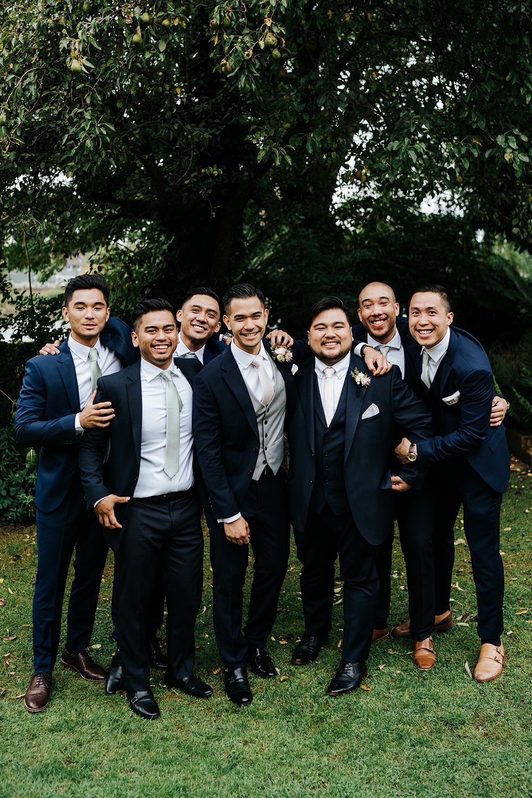 Staged group shot of groom and his groomsmen after wedding ceremony