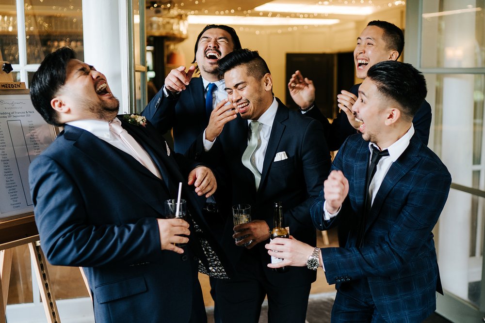 Groom and his mates share a moment of laughter during cocktail hour
