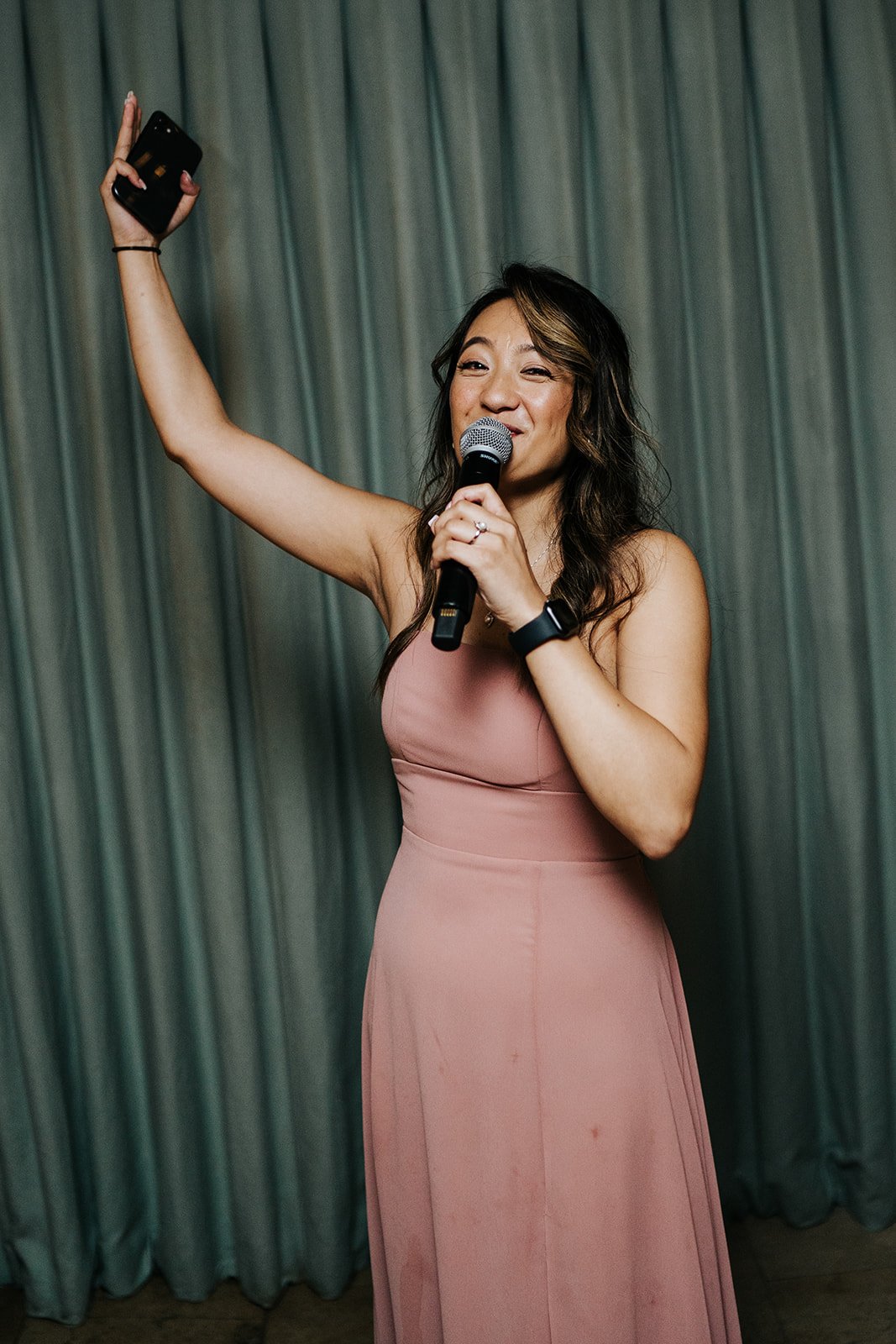 Sister of the bride grabs the microphone to motivate the lively crowd at bingham riverhouse