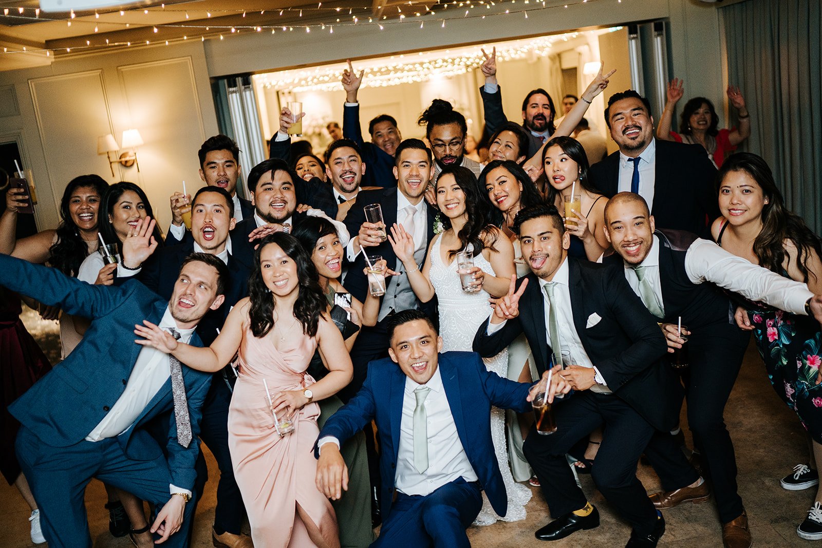 Group photograph on dancefloor of bride, groom and their closest friends enjoying the evening party at Bingham Riverhouse wedding