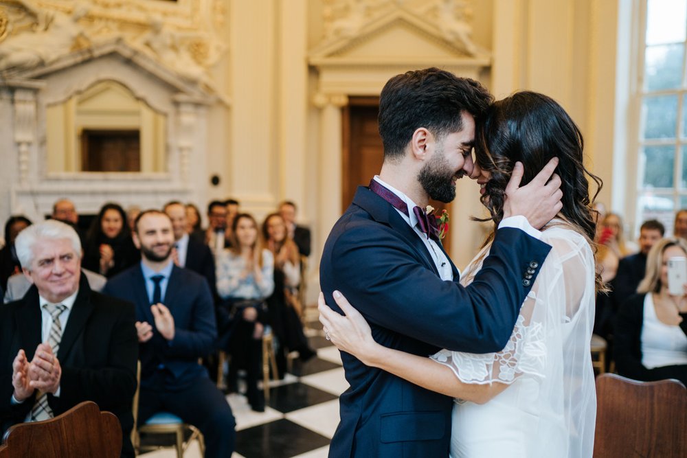 Bride and groom touch foreheads after sharing first kiss during Orleans House Gallery ceremony