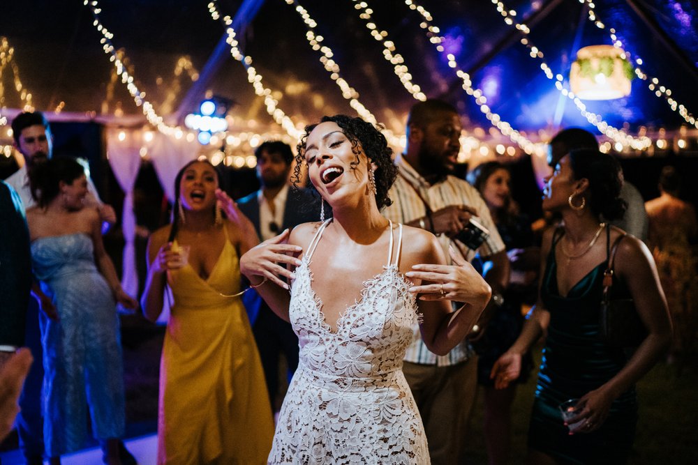 Bride, in white lacey dress, dances on dancefloor at Puerto Rico wedding in Vieques