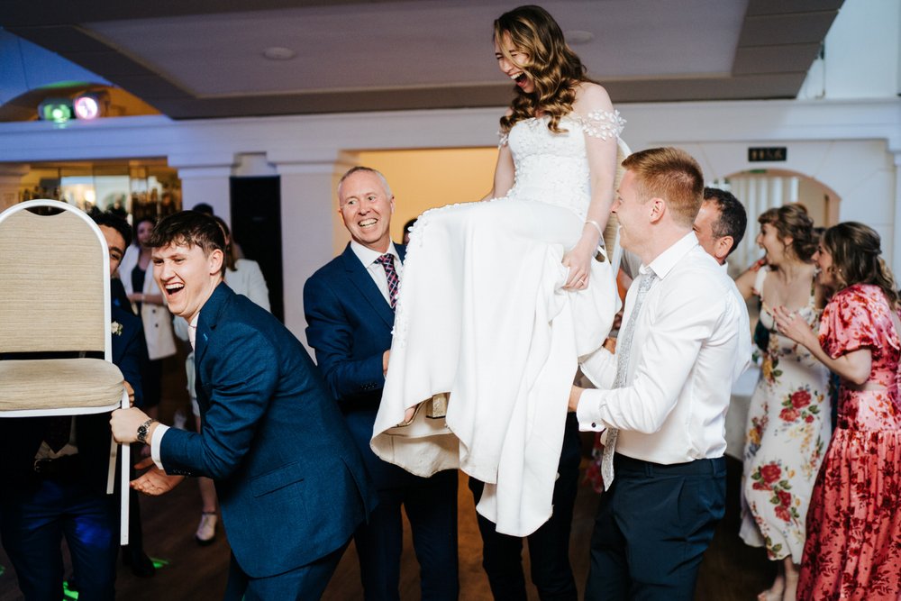 Bride and groom do Jewish hora dance at Pembroke Lodge wedding