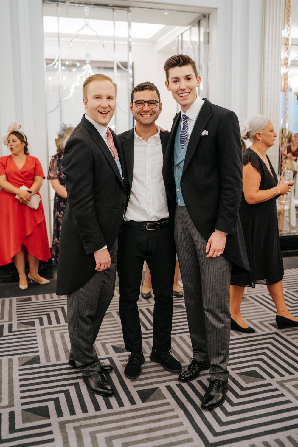 Michael Maurer Photography stands with William Hanson and Michael Worrall for staged photograph at Claridge's wedding