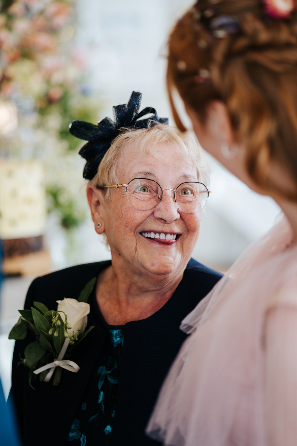 Grandmother of the bride sticks tongue out at bride during Twickenham wedding