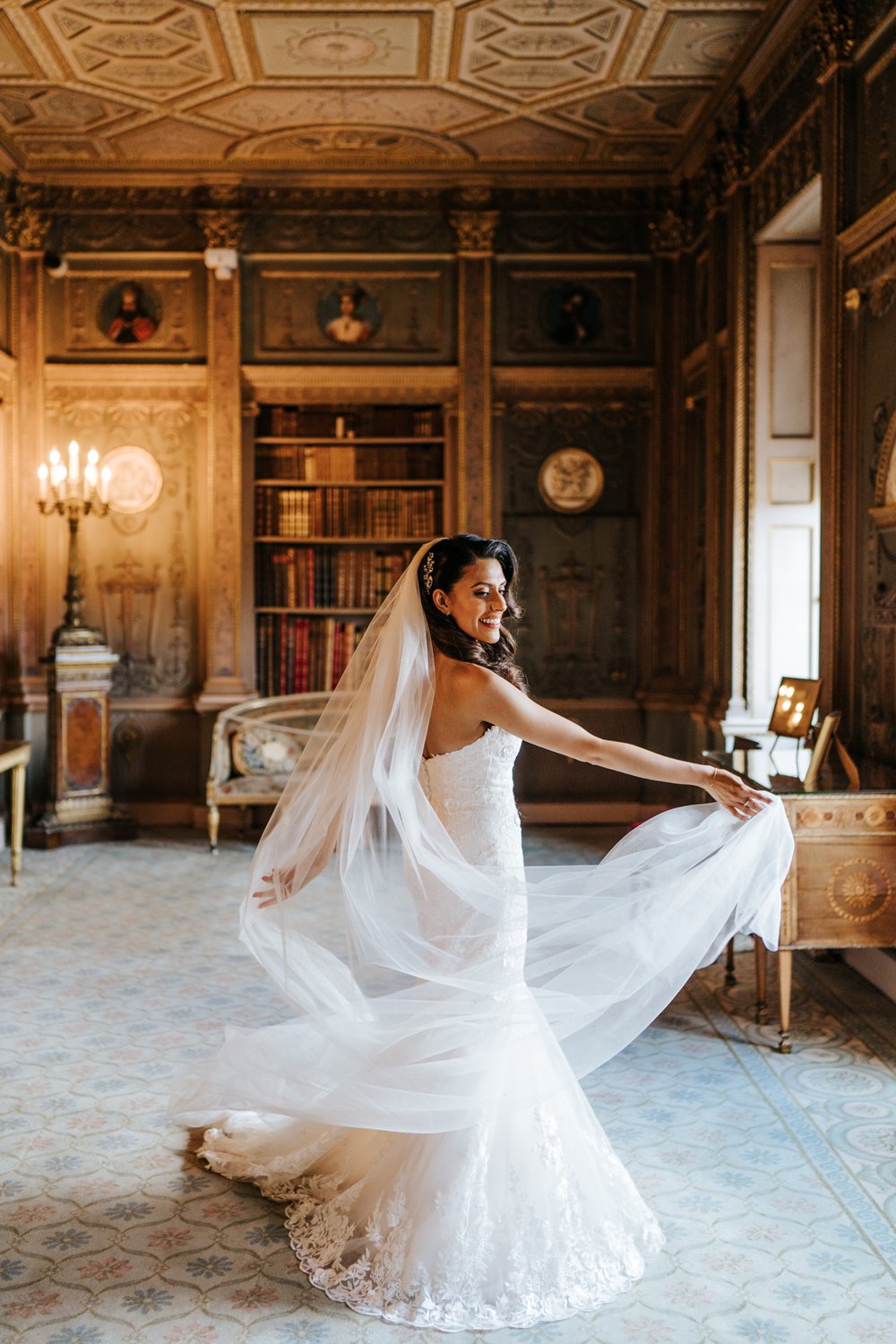 Bride twirls her white dress in Syon Park's long gallery after wedding ceremony
