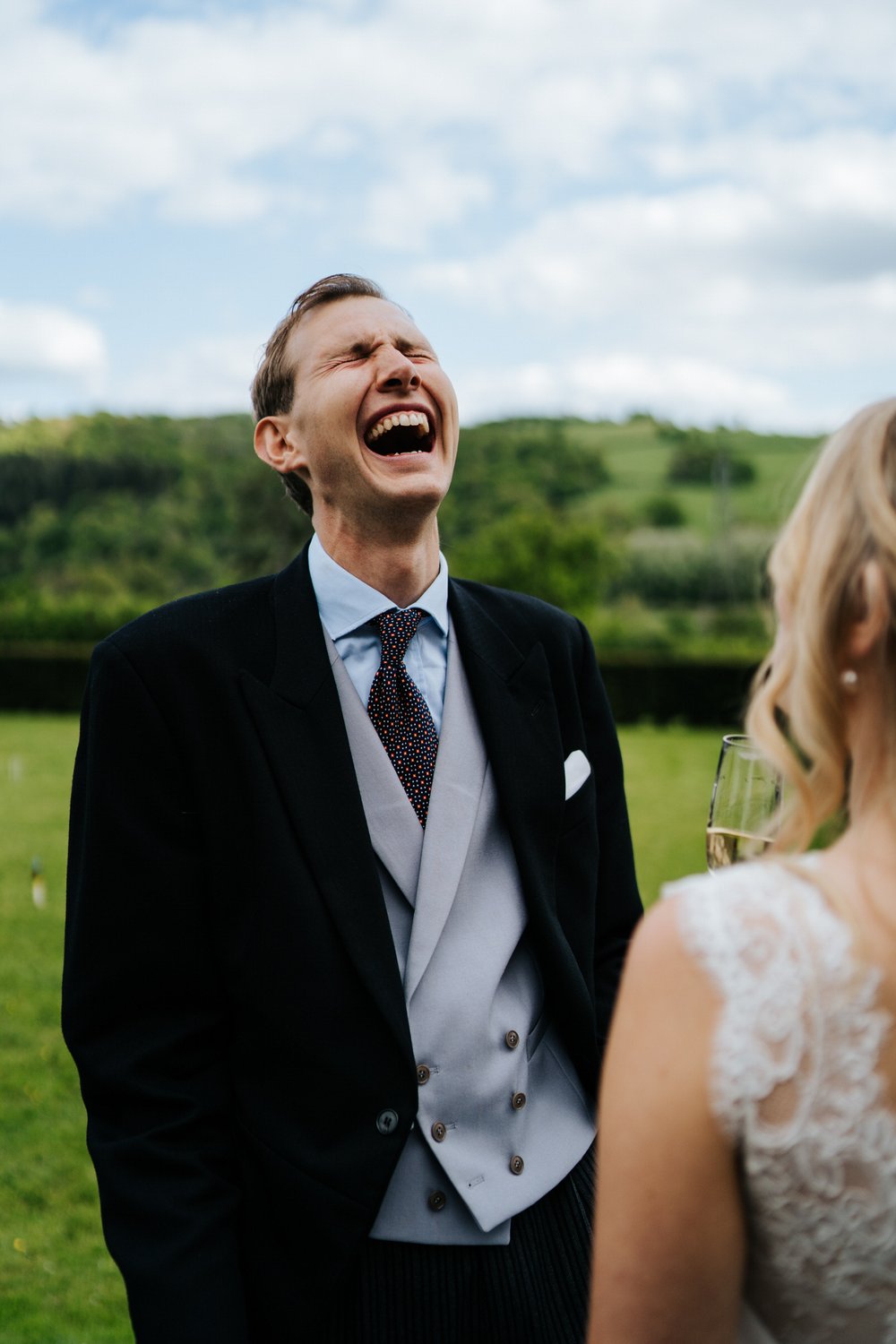Guests recoils in laughter as he speaks to bride during Pynes House wedding 