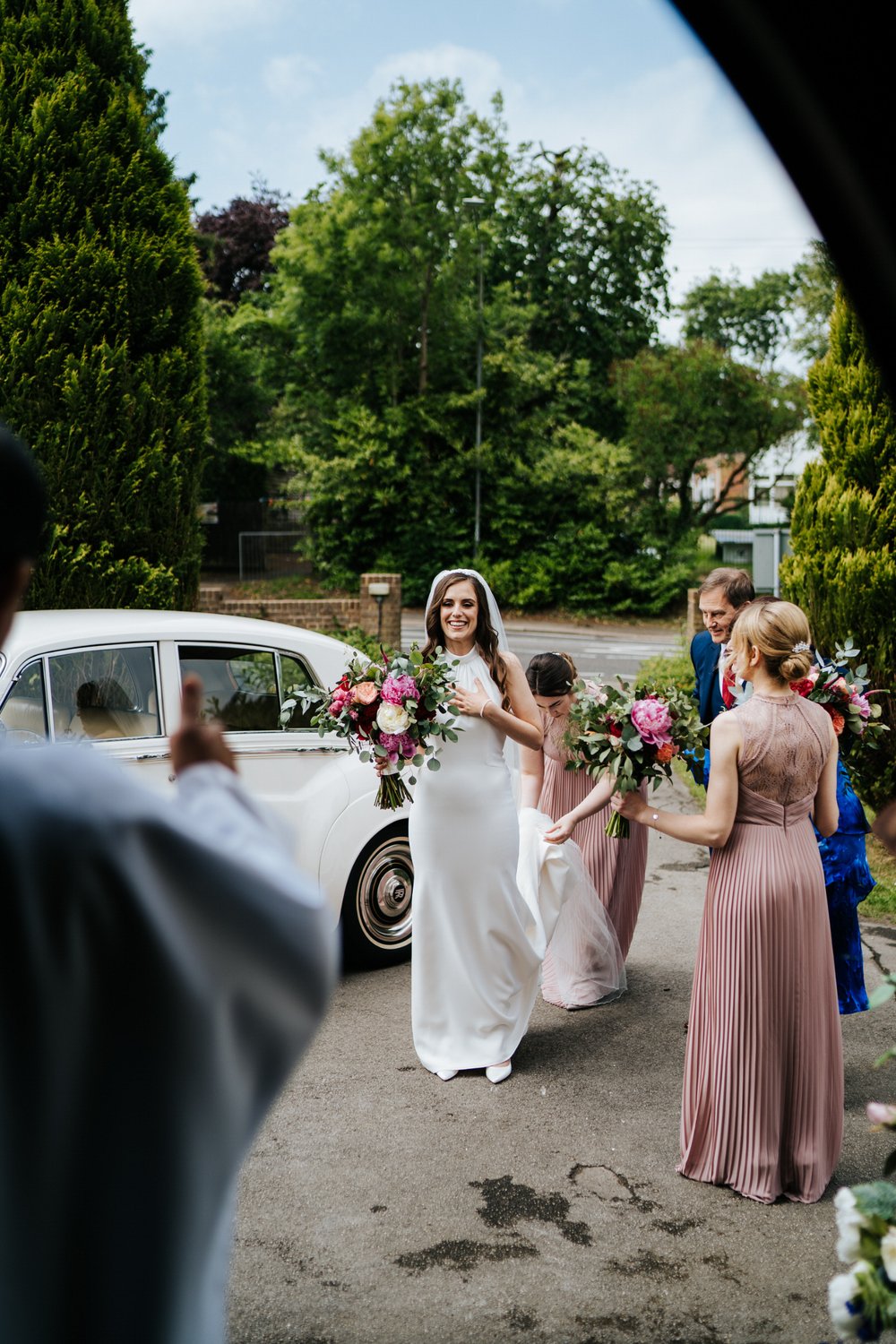 Bride seen arriving at church and checking her heart-rate as vicar gives her the thumbs up that everything is ready to go 