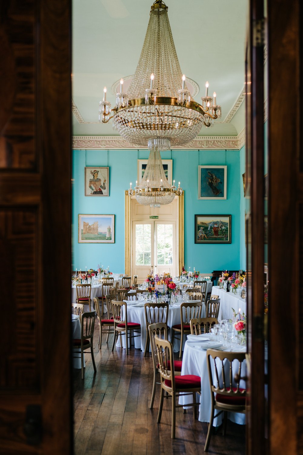 Photograph of quirky reception room at Walcot Hall with blue walls and ornate chandelier