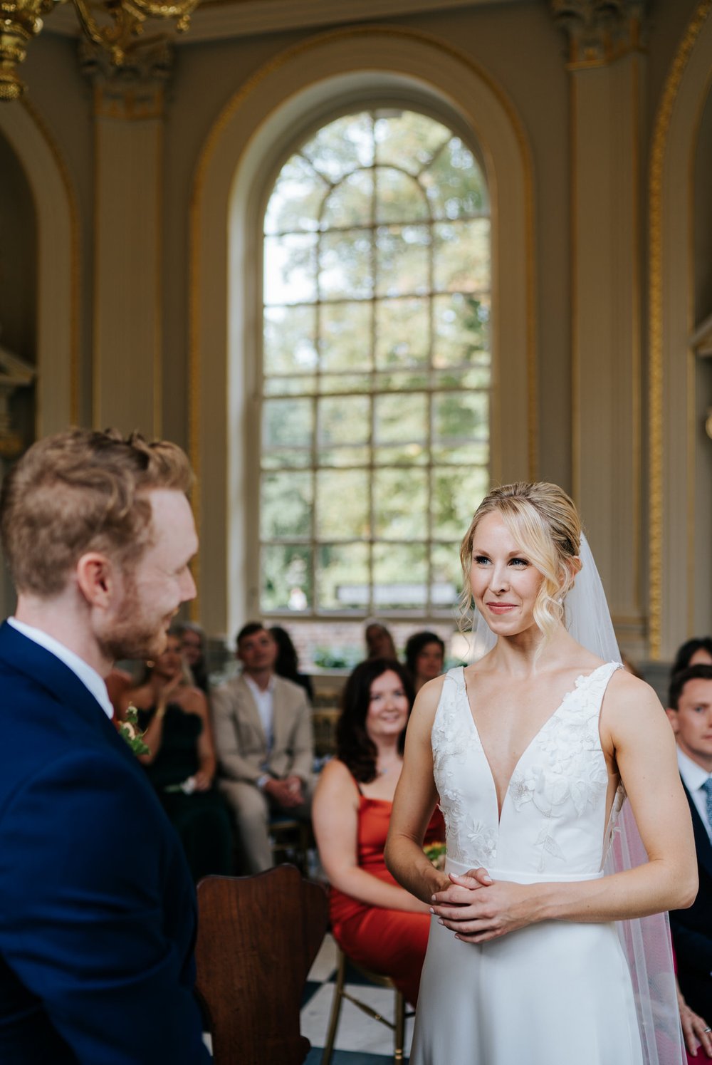 Bride looks at groom during wedding ceremony at Orleans House Gallery wedding