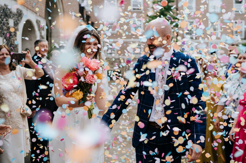 Bride and groom are barely discernable in sea of confetti