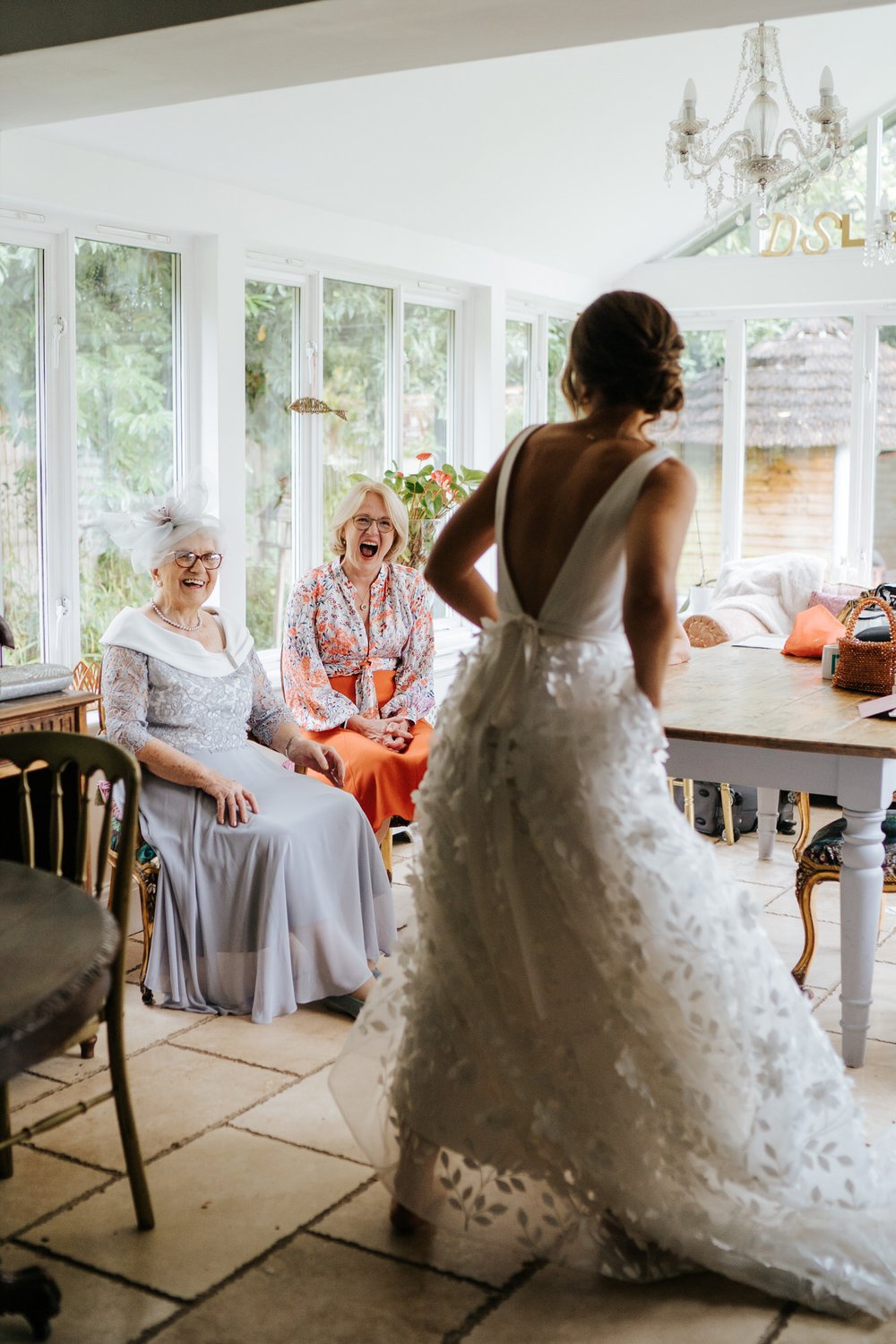 Bride's mother and grandmother react to seeing the bride in her wedding dress
