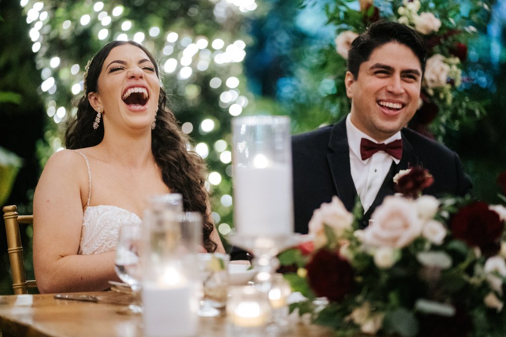 Close-up of bride and groom as they both smile during their wedding speeches at Villa Woodbine Miami