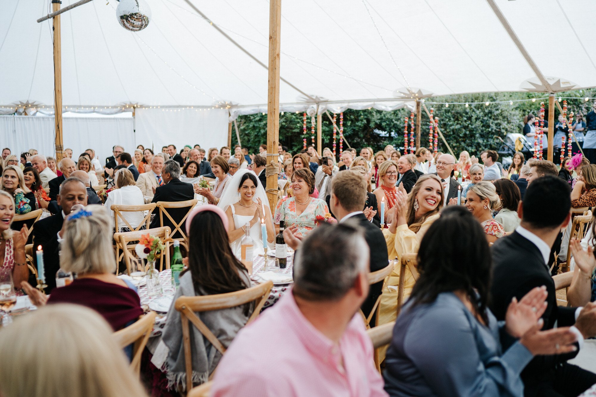 Wide photograph of wedding marquee with bride and her mother in the middle