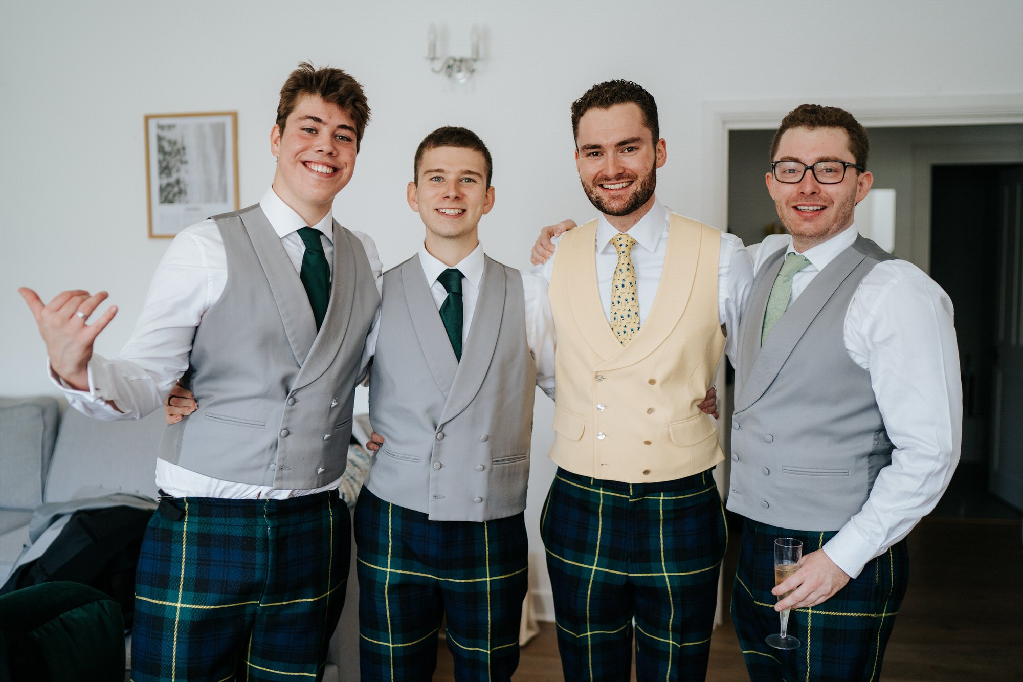 casual group shot of the groom, his brother and the bride's two brothers looking at the camera