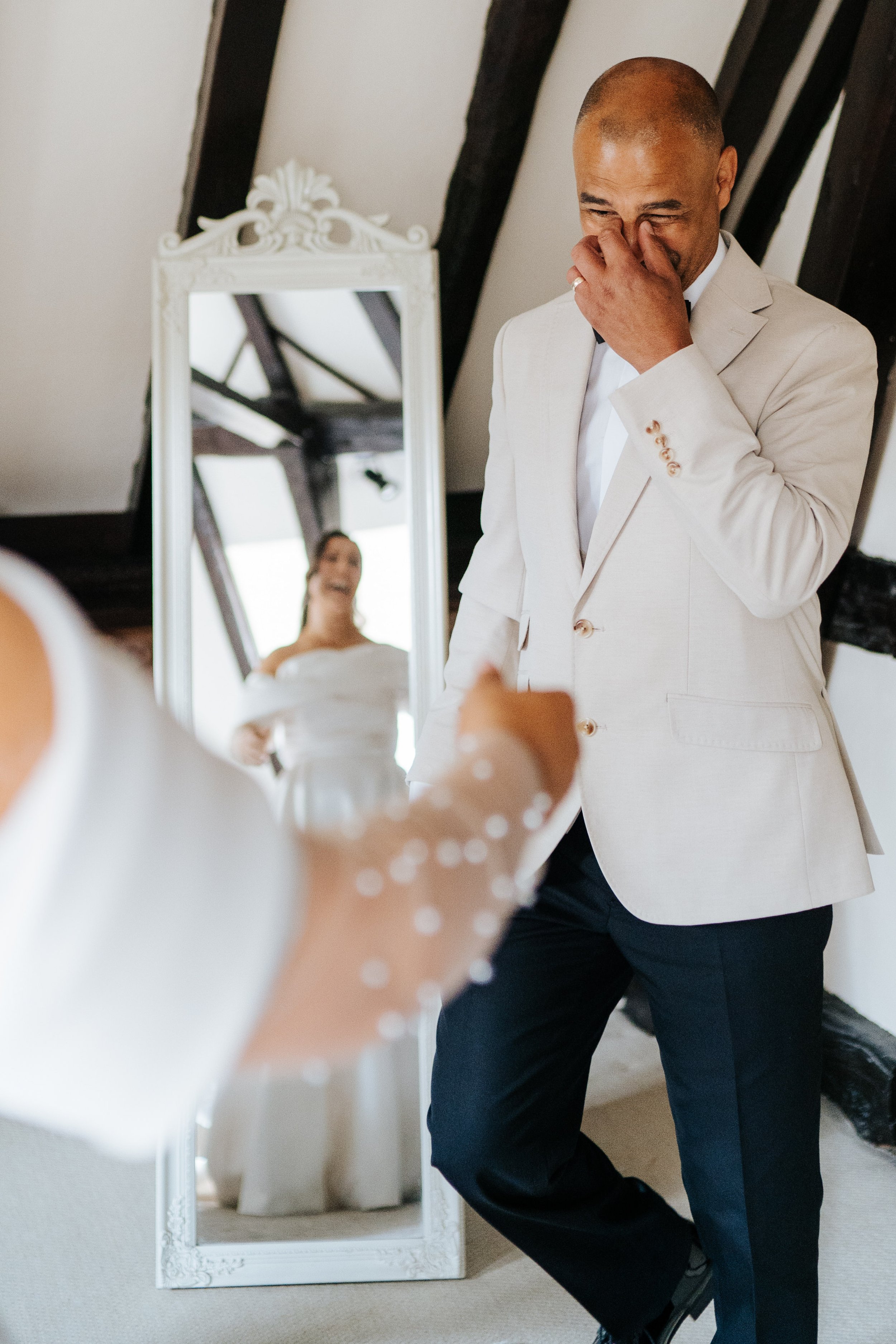 Father of the bride reacts with glee as he sees his daughter in her wedding dress for the first time
