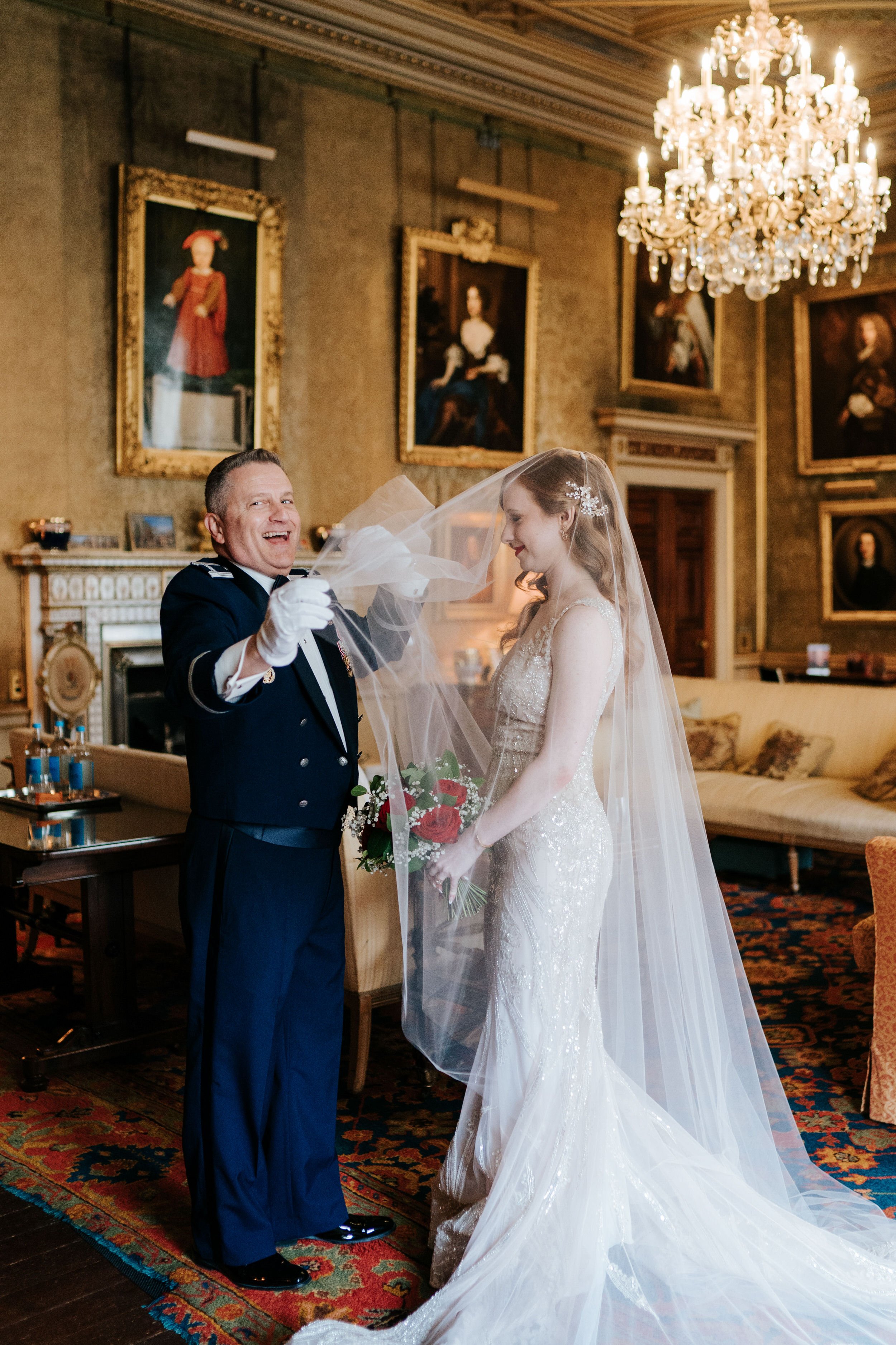 Father of the bride smiles as he learns how to remove her veil minutes before Syon park ceremony