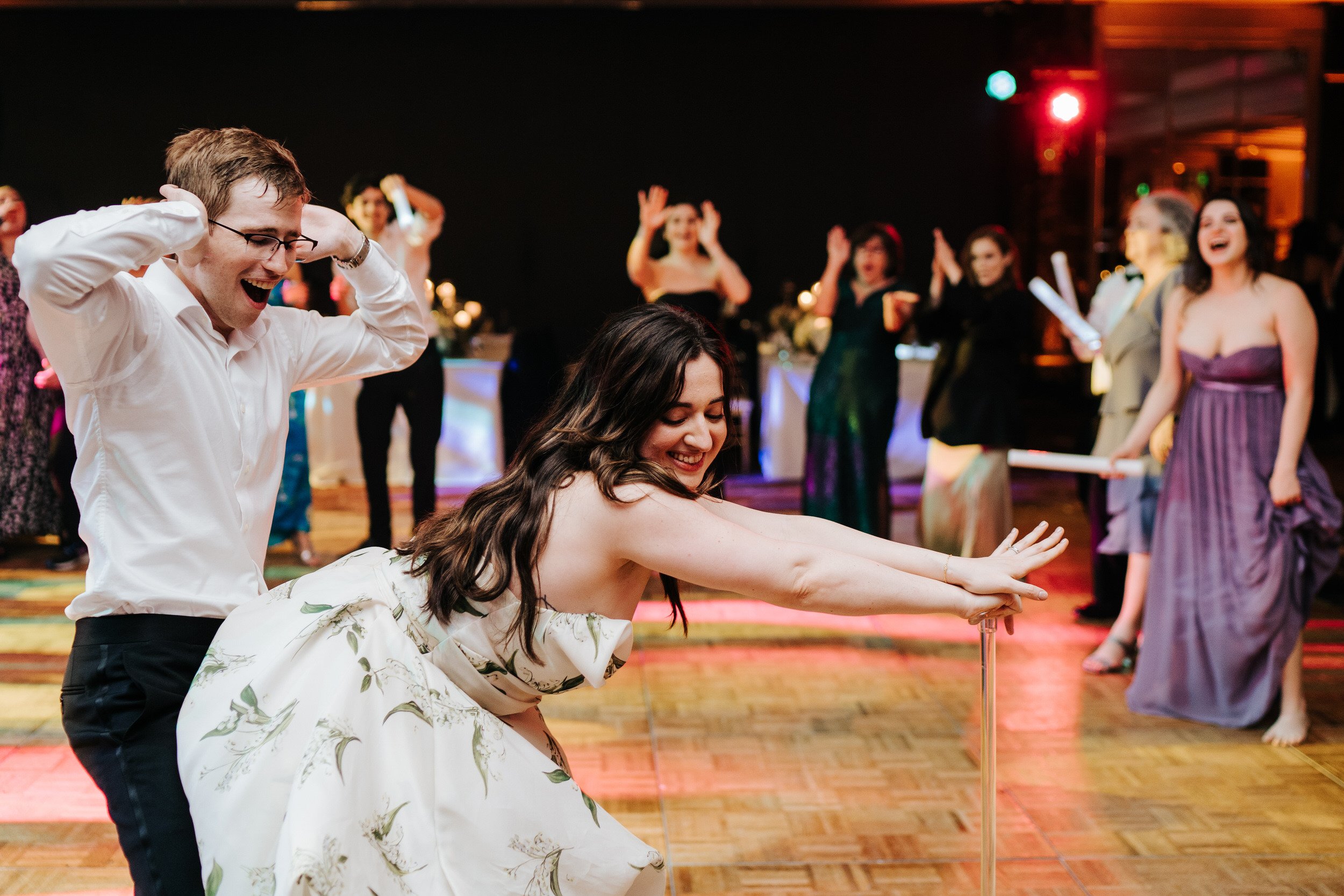 Bride grinds on husband as she leans forward while supporting herself on her cane at Puerto Rico Vanderbilt wedding ceremony