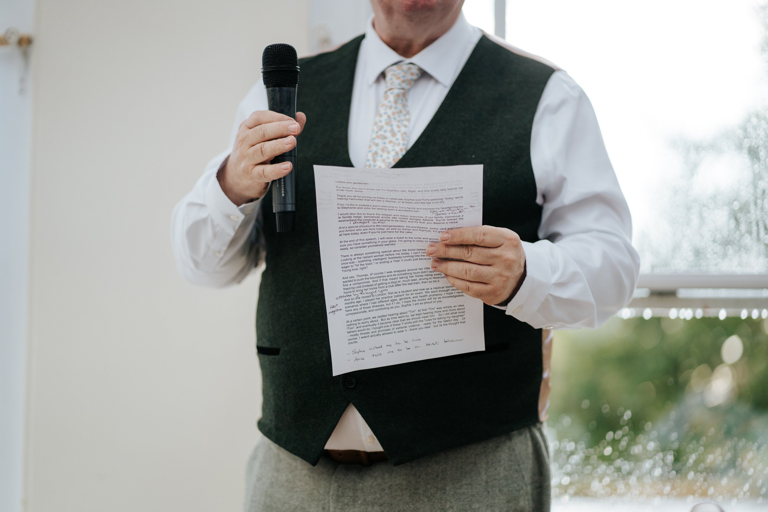 Father of the bride holds his annotated wedding speech