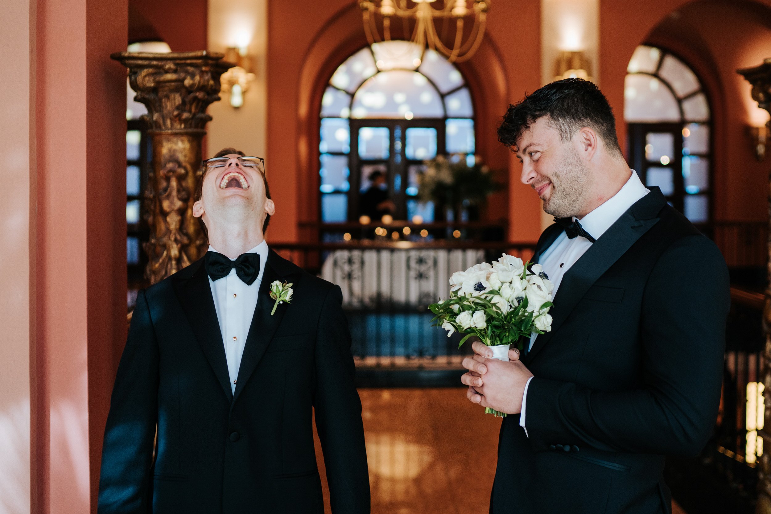 Groom laughs hysterically as one of his groomsmen pretends to be bride during first look at Puerto Rico wedding