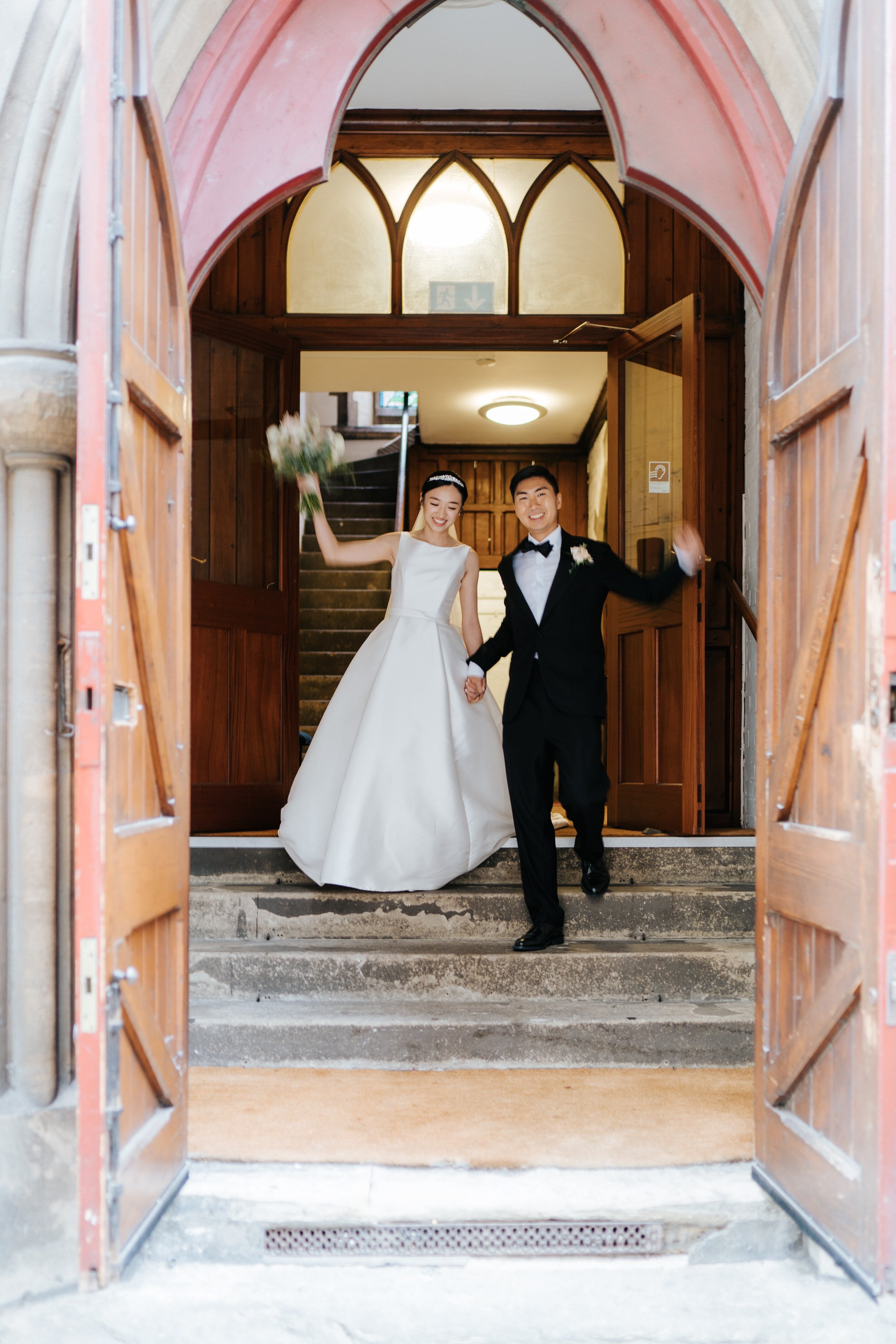 Bride and groom exit church in excitement after London church ceremony ends