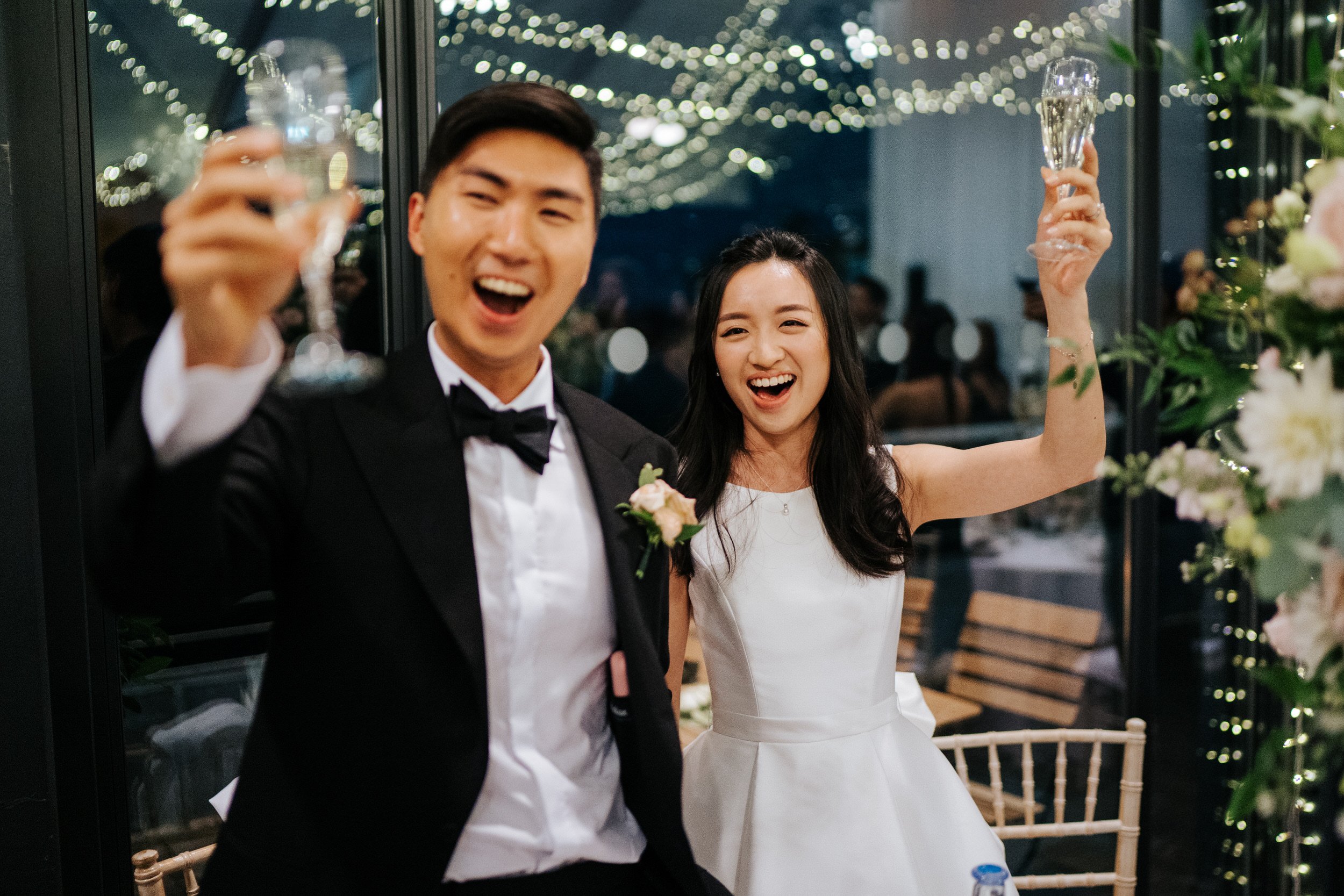 Bride and groom do a Singaporean toast to all of their guests during wedding reception