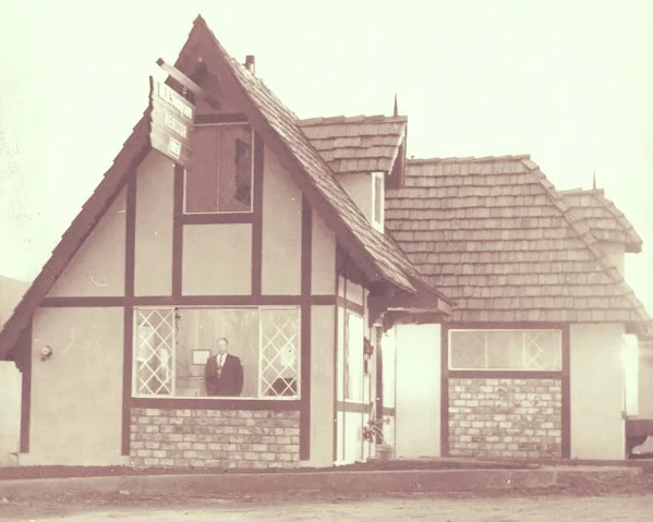 Maury Sampson checking out the neighborhood from his newly compleated real estate office.