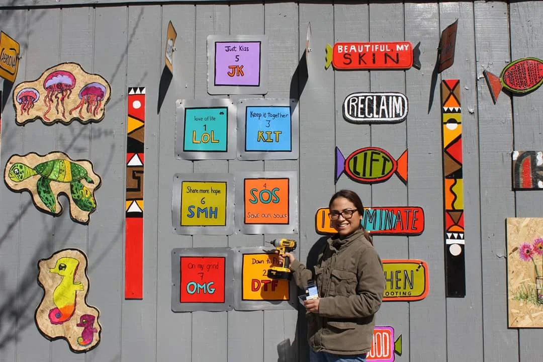 Sandra Lara aids in installing ‘Community Candies’ on 79th and Exchange part of a group show, November 2016.