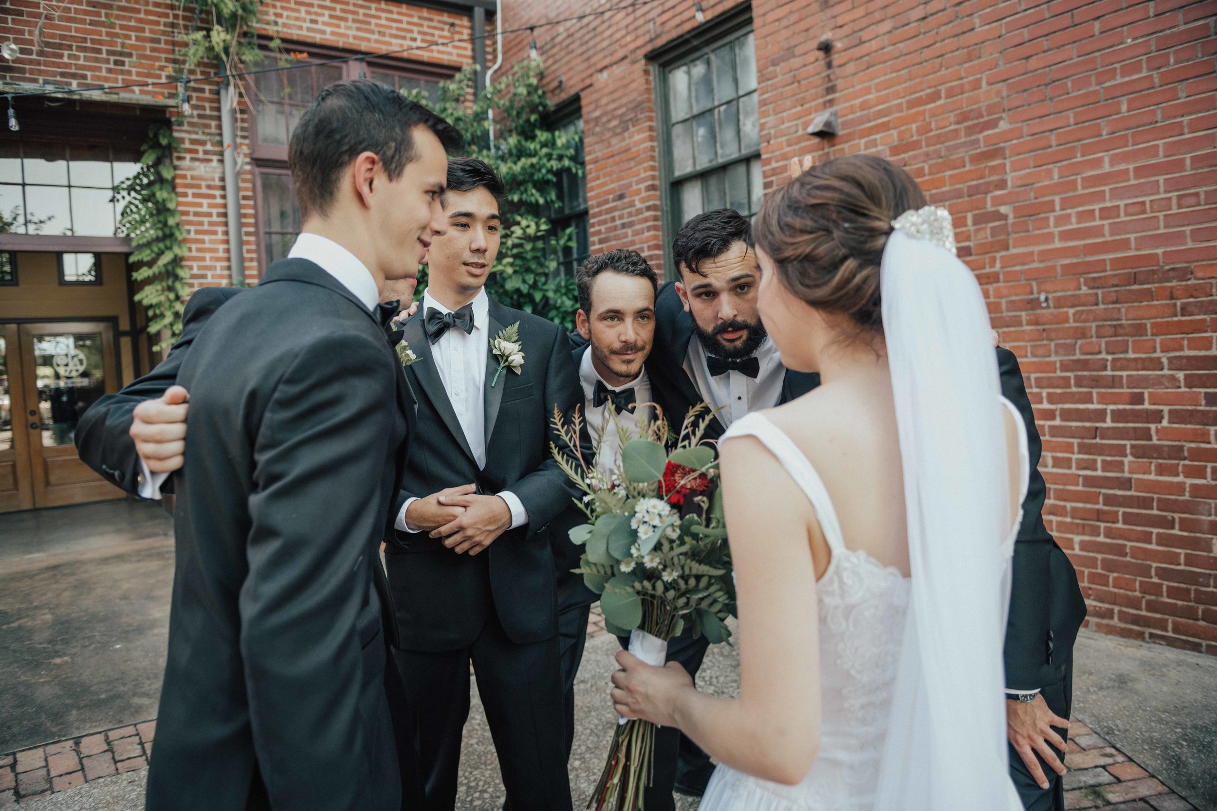 Love when the bride pulls all the groomsmen together to give them the game plan for the day!