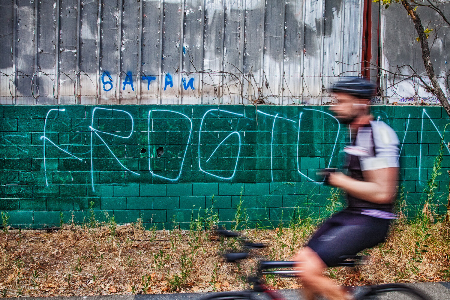  Graffiti and cyclist along bike path in Frogtown. 