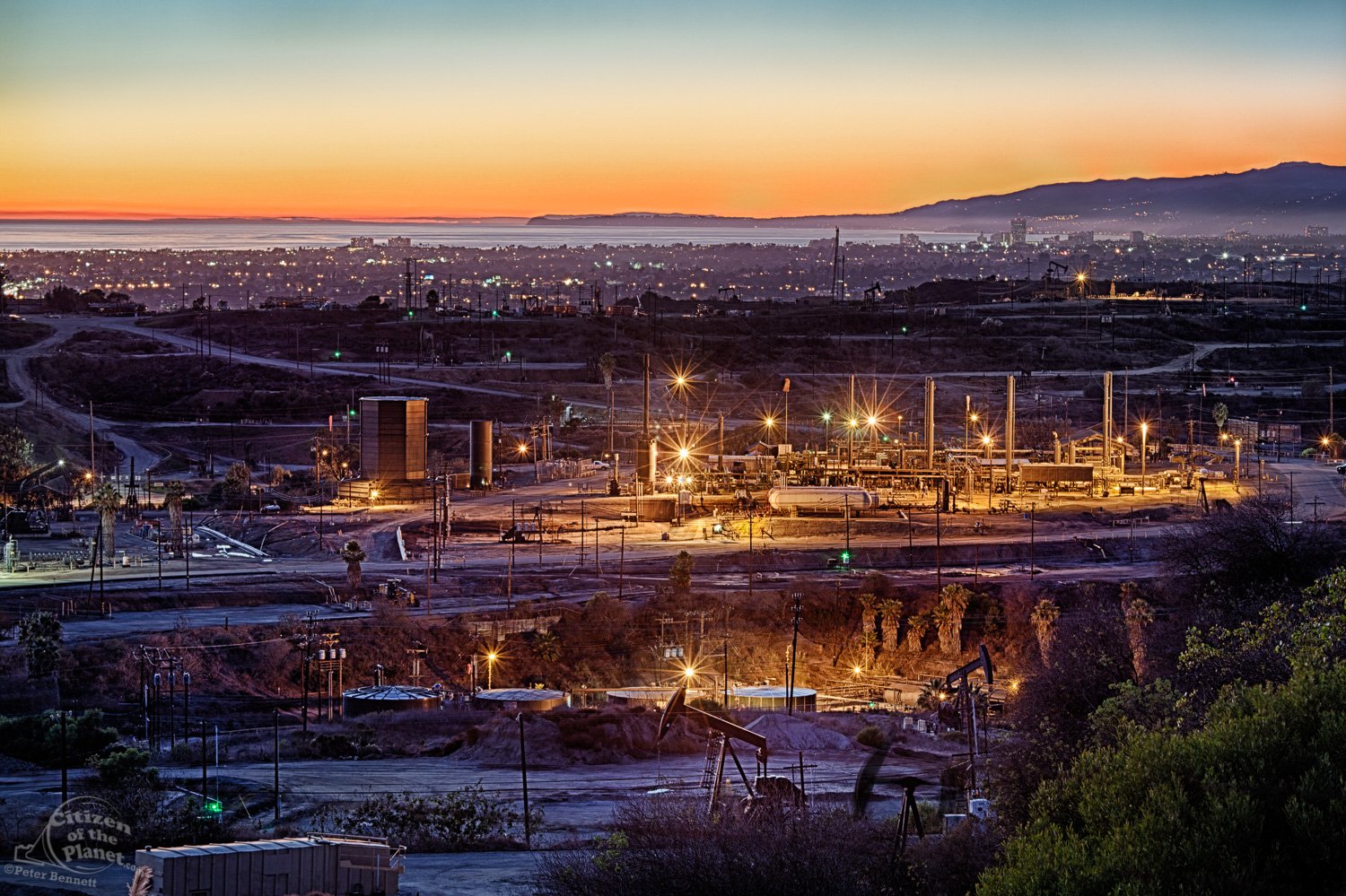  Inglewood Oil Field, one of the largest urban oil fields in the country, with city of Santa Monica and Malibu coastline in the background. 