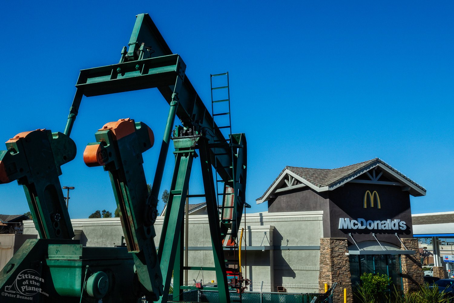  Oil well and pumpjacks next to a McDonald's in the City of Signal Hill. 