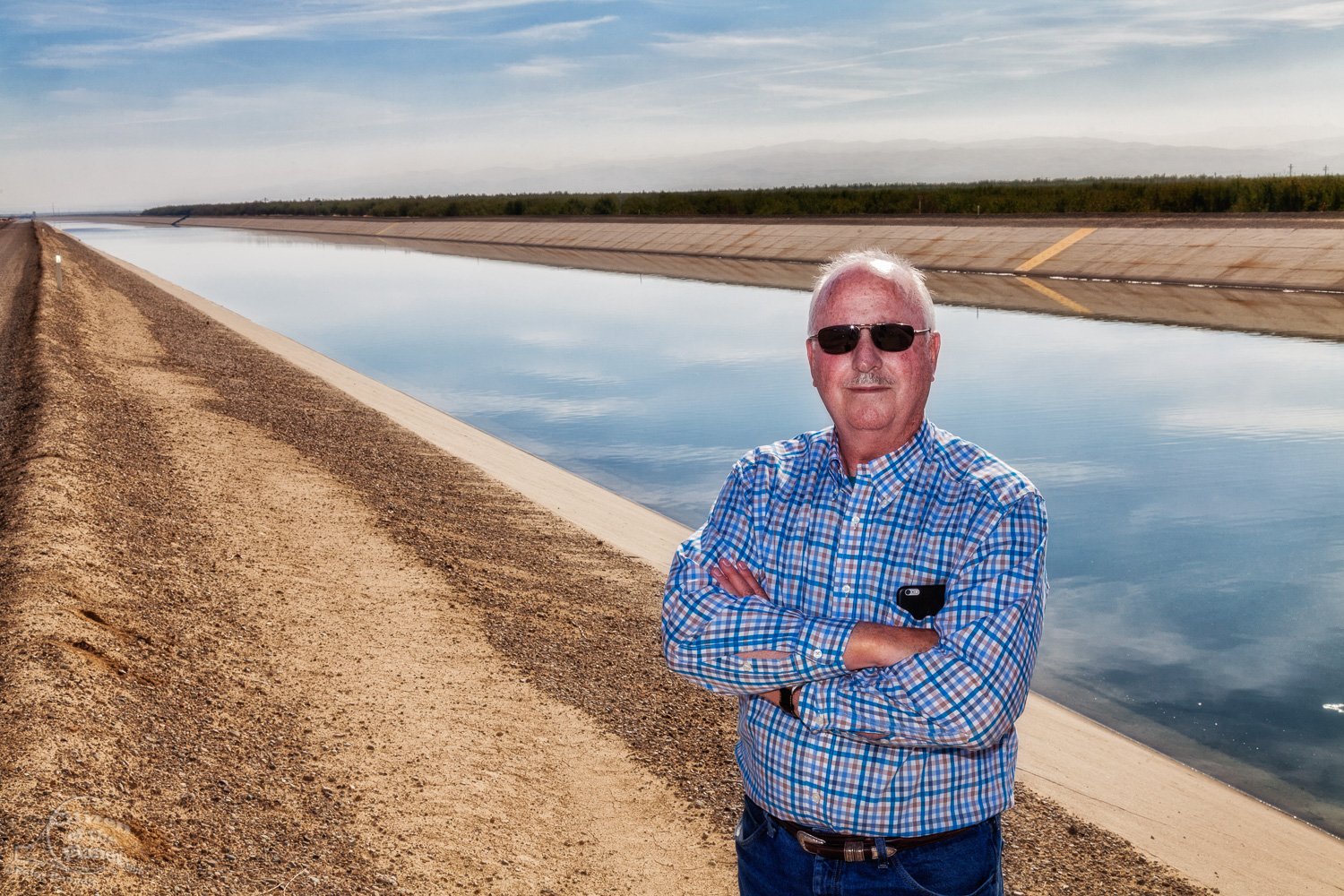  Rod Cardella stands in front of the California Aqueduct next to his family  farm which was severely affected by three years of severe drought. 