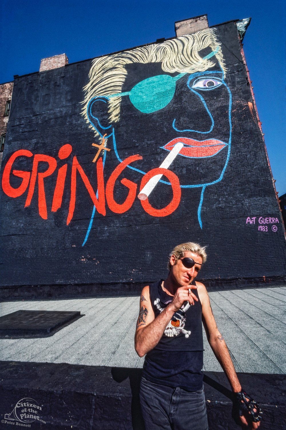 John Spacely in front of Gringo mural by Art Guerra