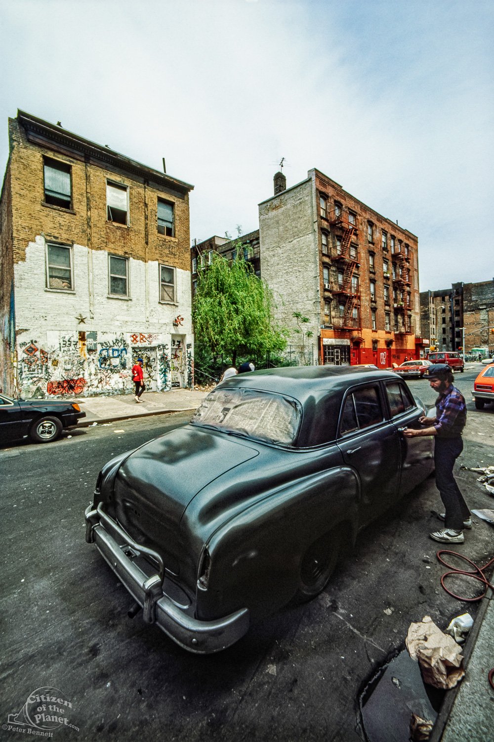  Working on a vintage car, East 8th Street, Club 8BC ion background, Alphabet City 