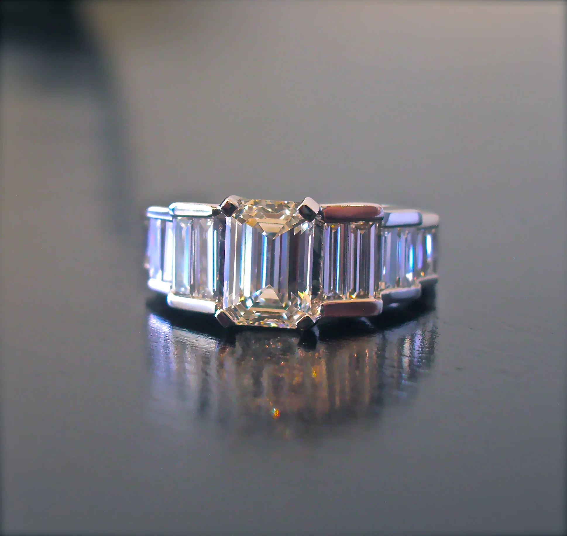  Emerald cut with tiered, twin baguettes. 