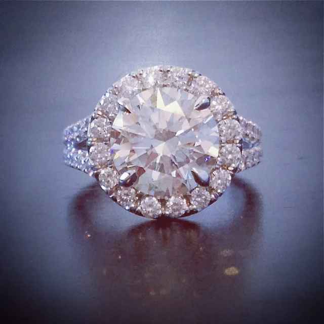  Custom, platinum, halo ring with 3.50 ct., round brilliant cut center. 
