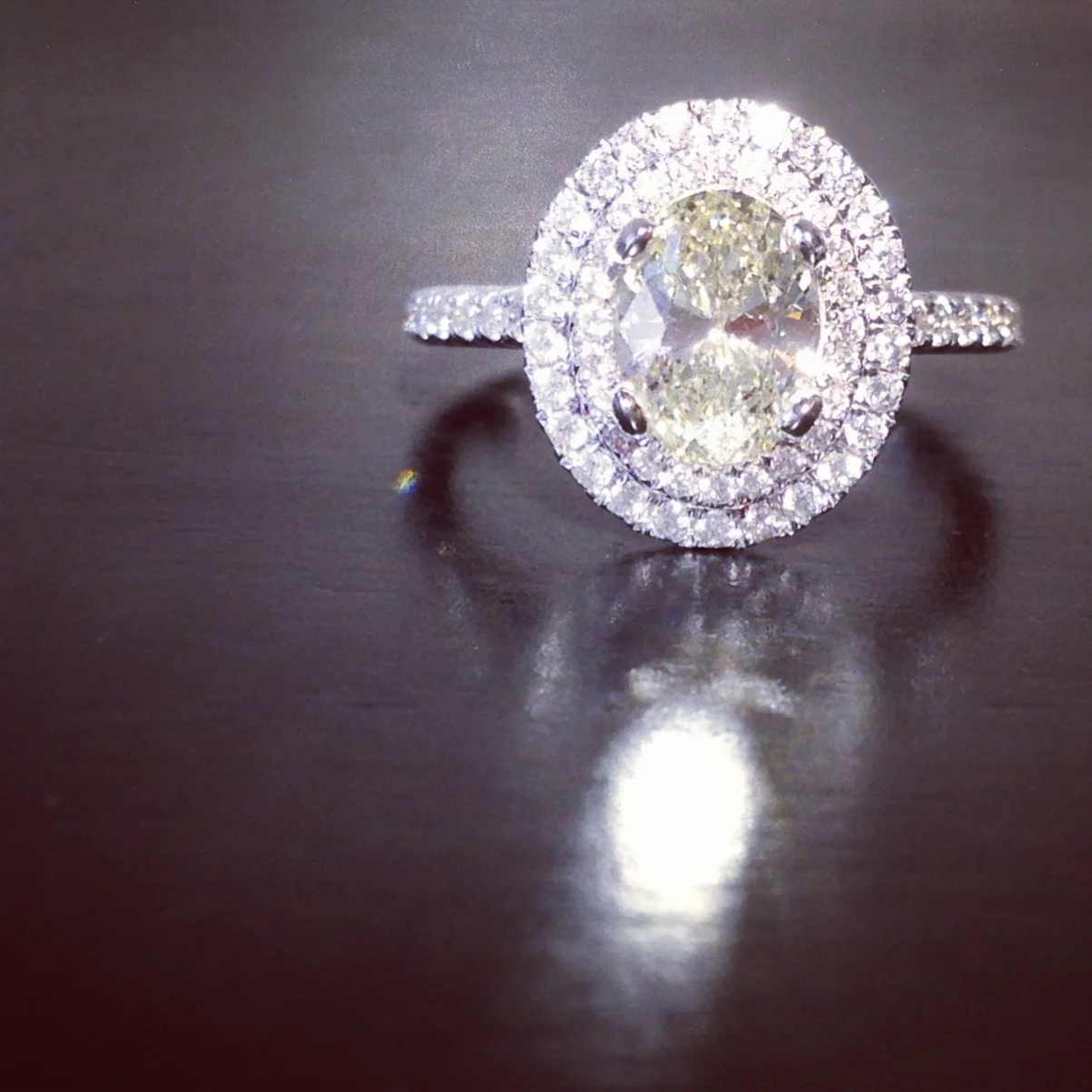  Double halo, diamond ring in 14k w.g. with 1.00 ct., champagne color, oval cut diamond center.&nbsp; 