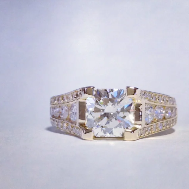  Custom "Prima Donna" ring with radiant cut center. 