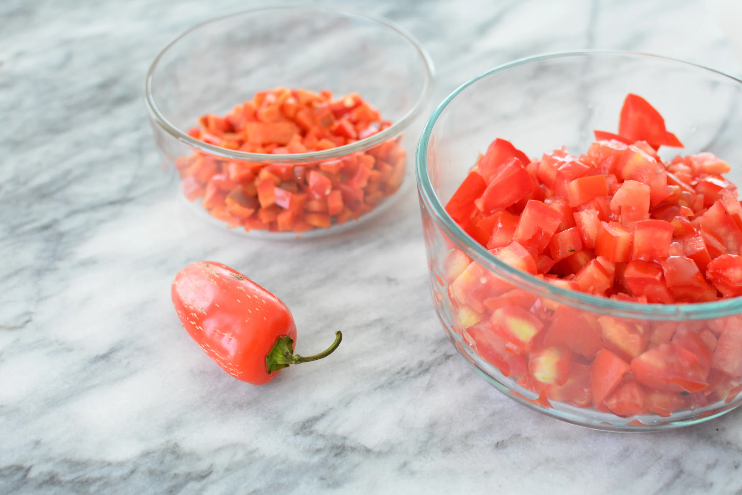 Tomatoes and two types of peppers for the pico de gallo.