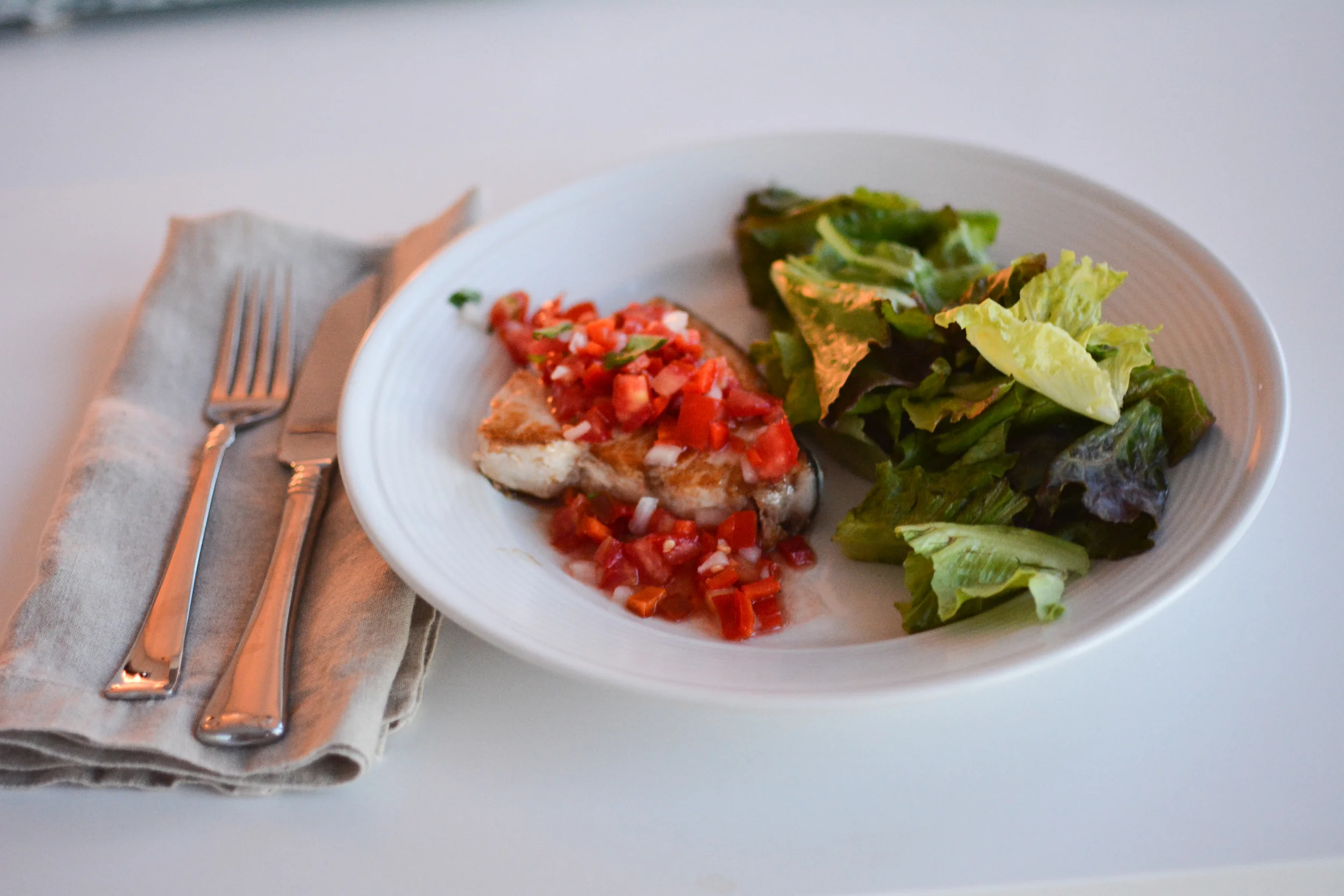 Pico de gallo served over swordfish steaks.