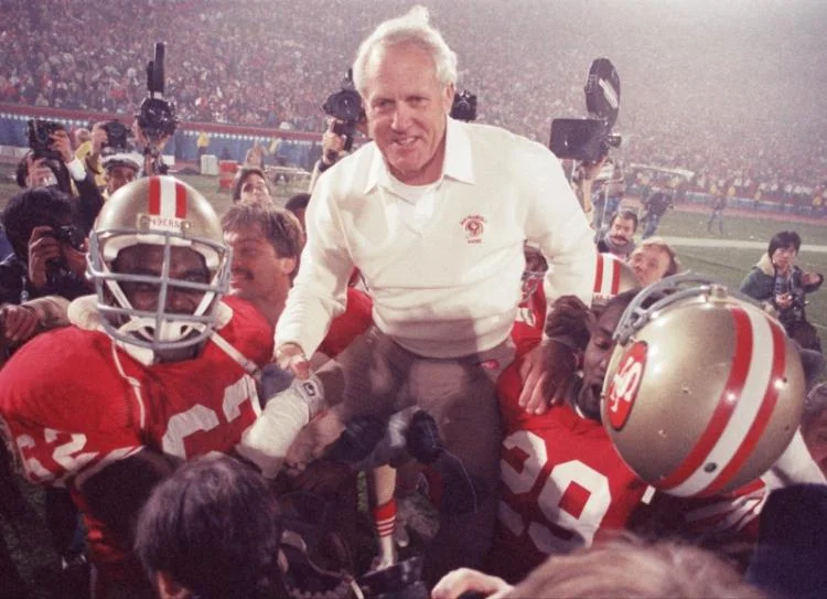 Bill Walsh hoisted up on the shoulders of his team, when the San Francisco 49ers defeated Miami, 38-16, in Super Bowl XIX in 1985