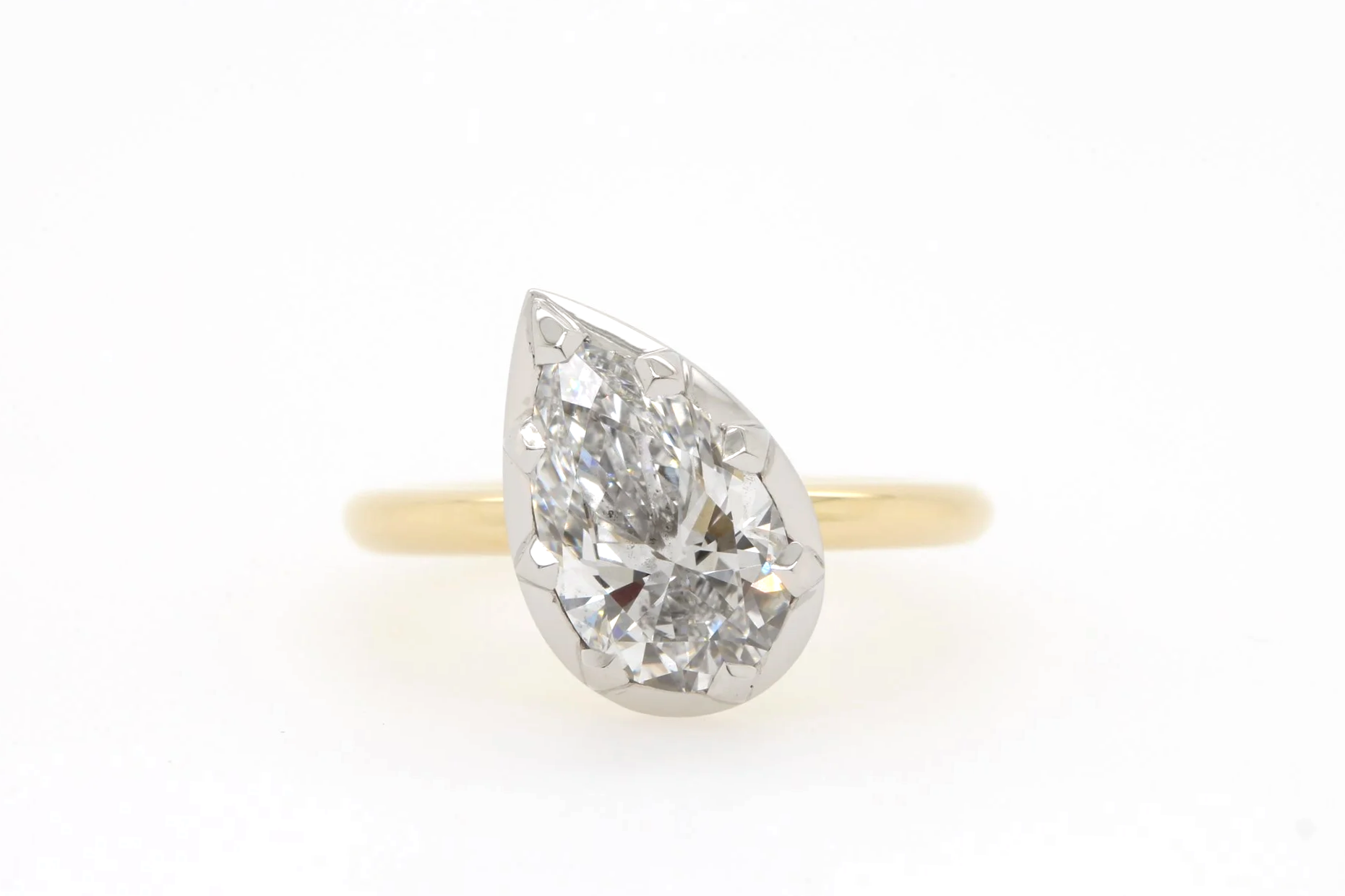Pear shaped diamond engagement ring with angled setting