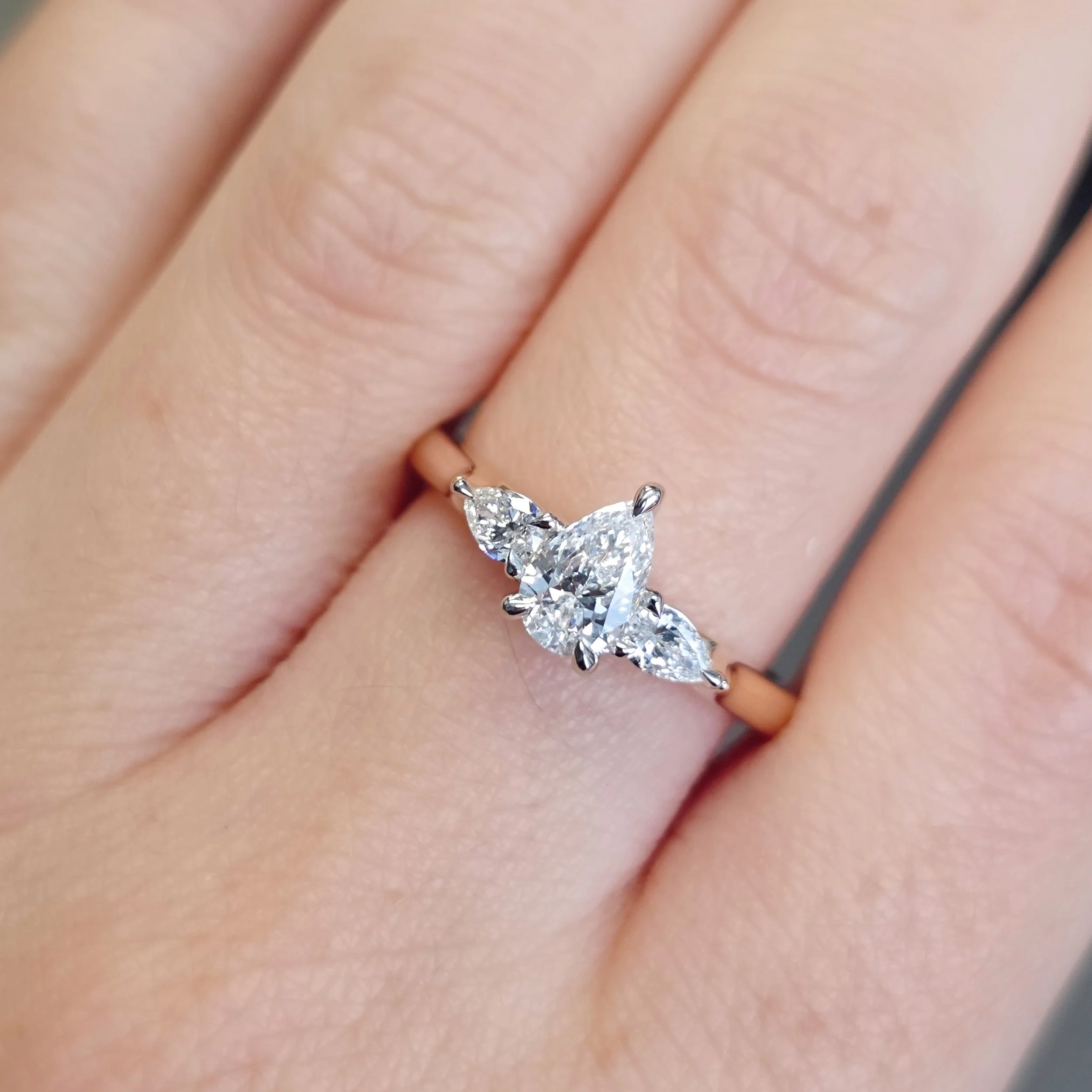 Pear Shaped Diamond ring with Pear Shoulders by Harlequin Jewellers Canberra on hand.jpg