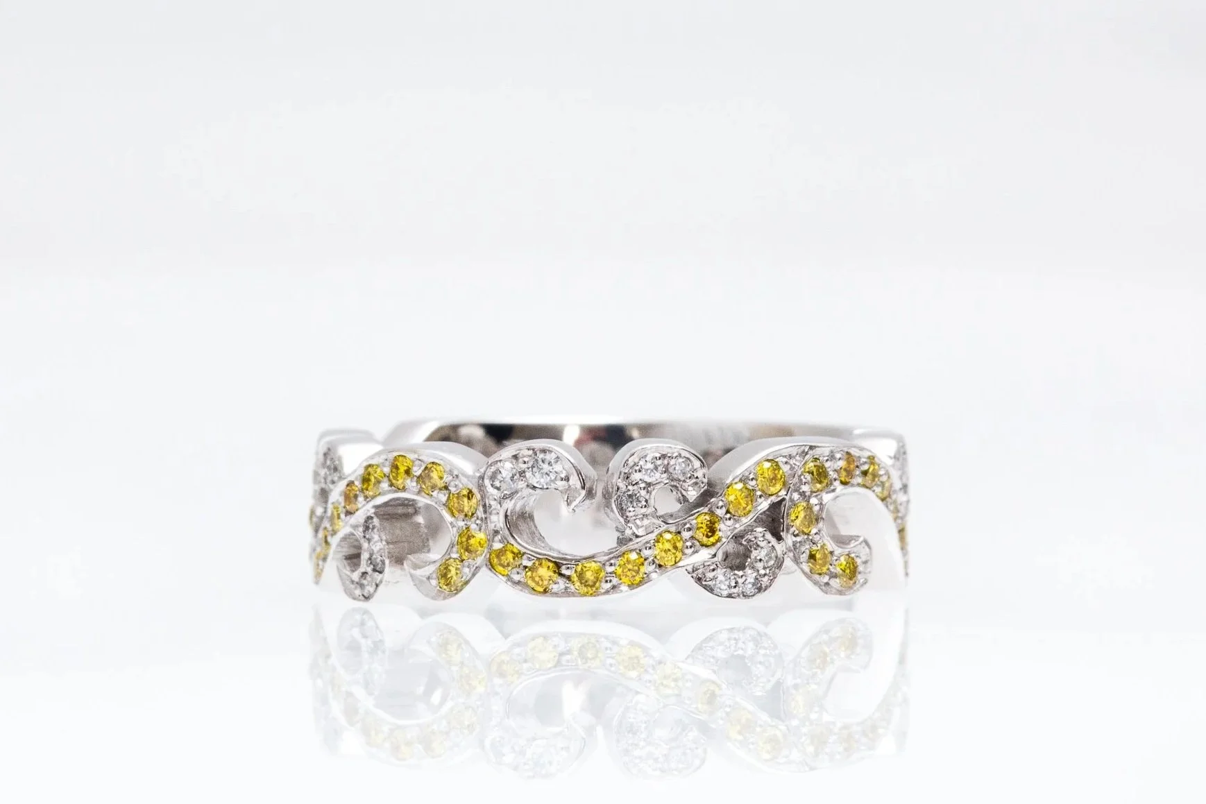 Custom filigree style ring with yellow and white grain set diamonds