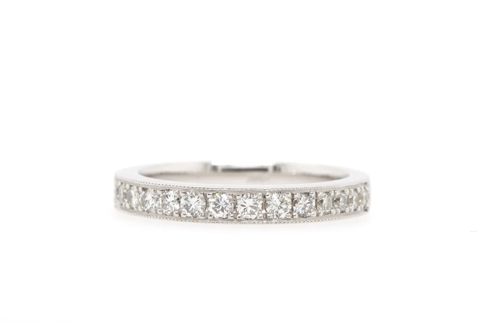 Classic diamond eternity ring design with grain set diamonds and milgrain edging