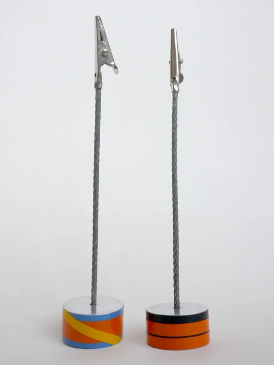  Crocodile clips soldered on to steel cable inerted and glued into a turned solid aluminium base covered with vinyl decals. 