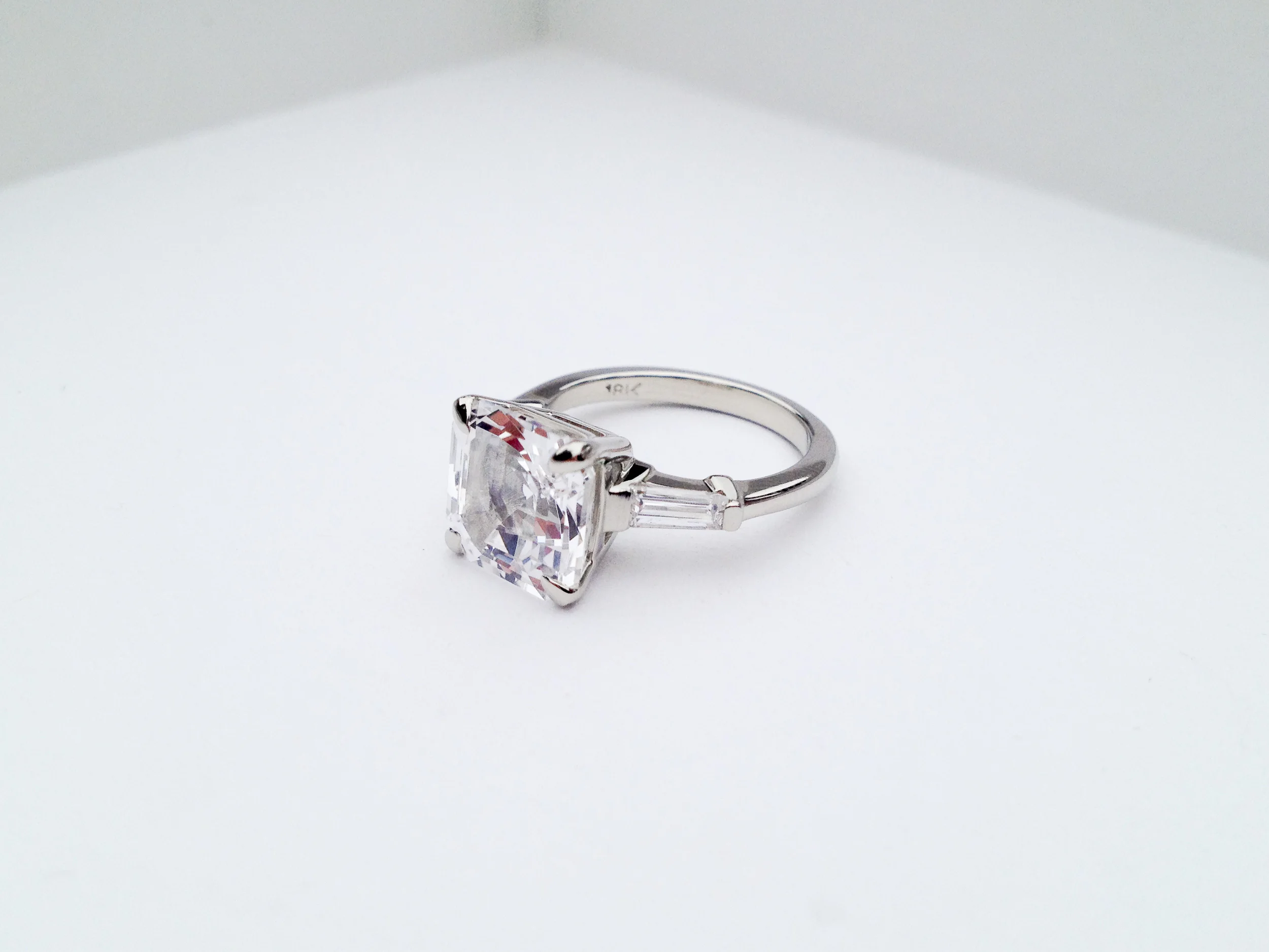 ADELE Engagement Ring: ethically-sourced, lab-created, asscher-cut white sapphire, baguette diamonds, 18k white gold.